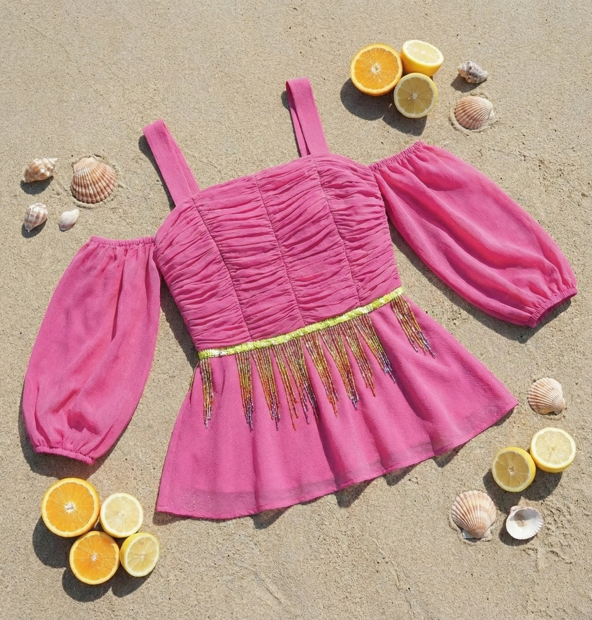 Top peplo rosa shocking con ricamo di paillettes
