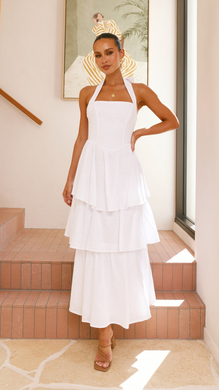White crepe tiered maxi dress with halter neckline and back tie-up bow