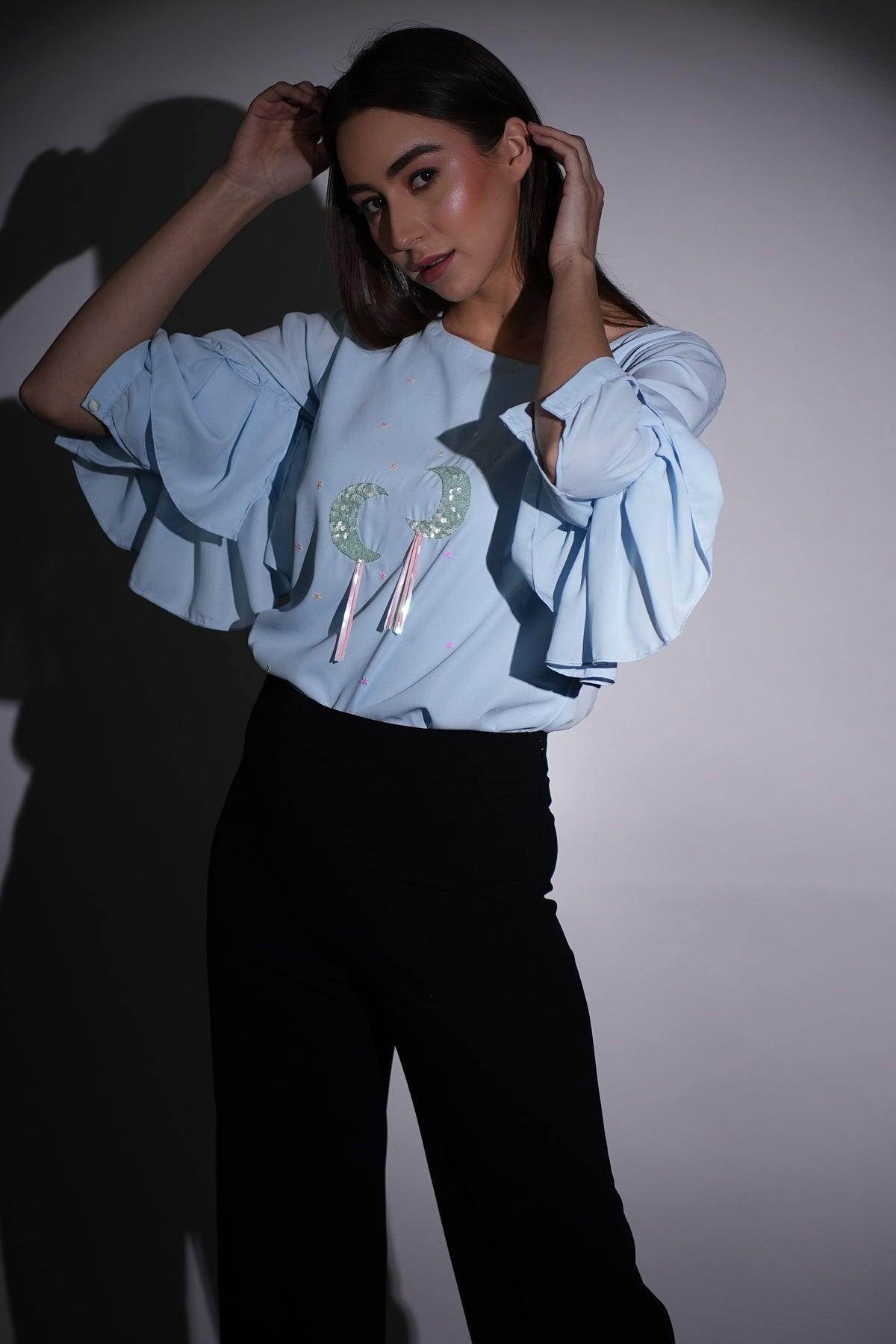 Top in georgette azzurro polvere con motivi lunari ricamati a mano