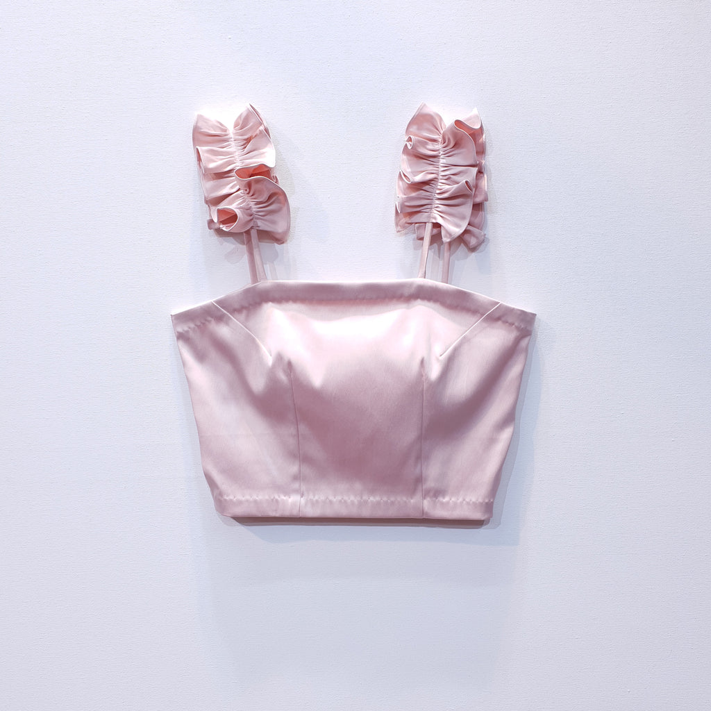 Pink duchess satin top with ruffle straps on a white background