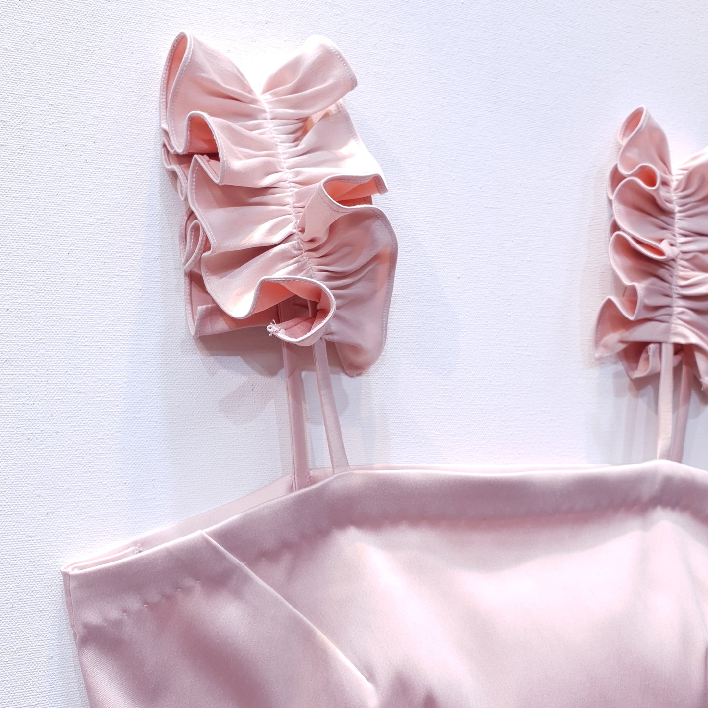 Pink duchess satin top with ruffle straps on a white background