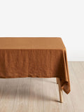 Brown tablecloth on a wooden table with a white background