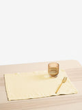 Butter Yellow napkin with a glass and fork on a wooden table