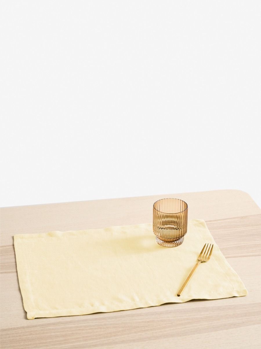 Butter Yellow napkin with a glass and fork on a wooden table