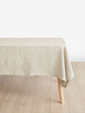 Beige tablecloth on a wooden table with a white background