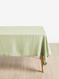 Green tablecloth on a wooden table with a white background