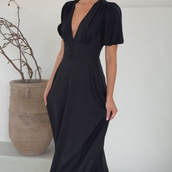 black linen puff sleeve maxi dress with a deep V neckline and flared skirt