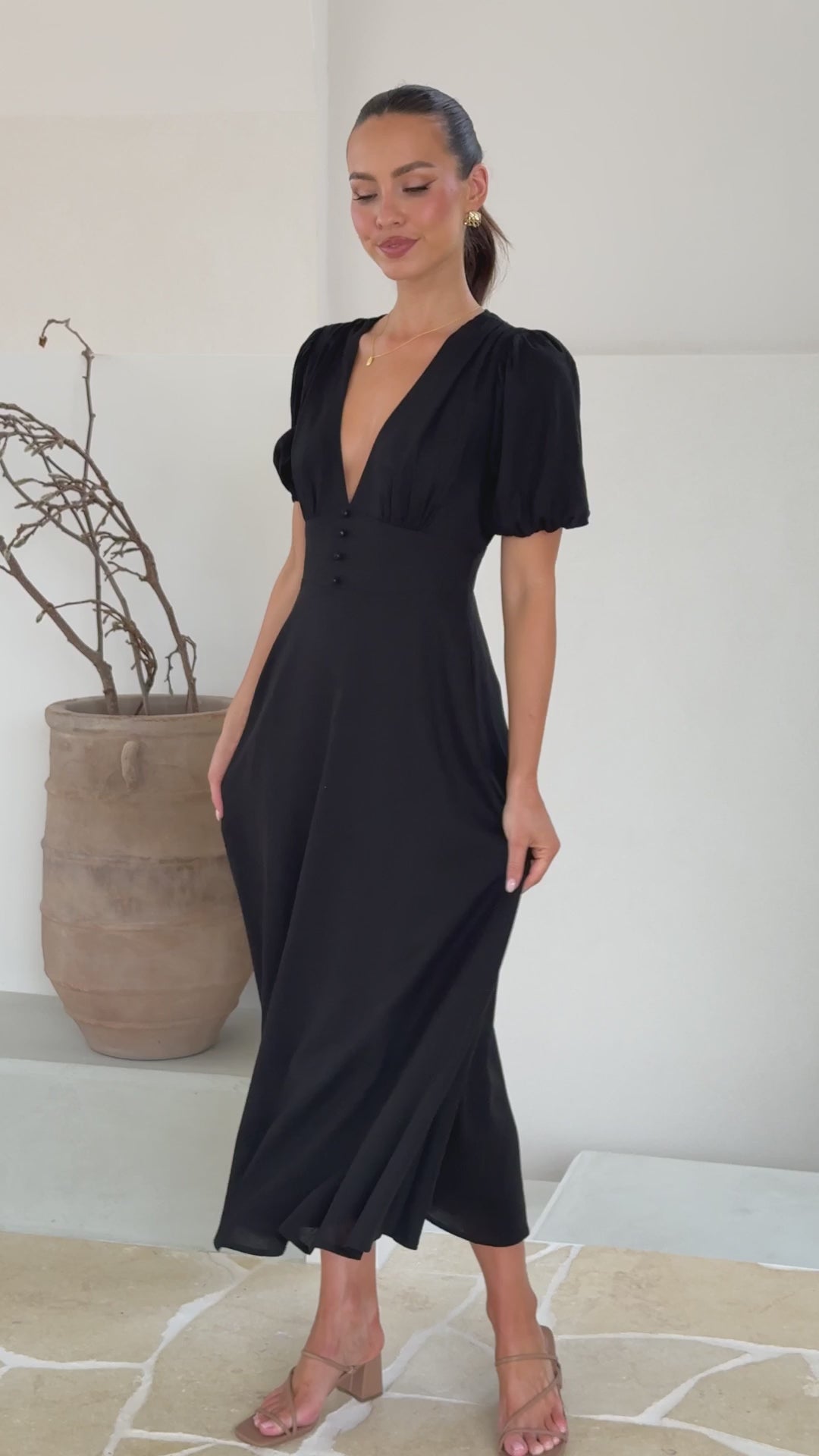 black linen puff sleeve maxi dress with a deep V neckline and flared skirt