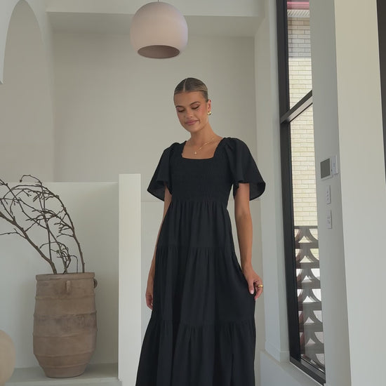 Black linen maxi dress with smocked bodice and flutter sleeves