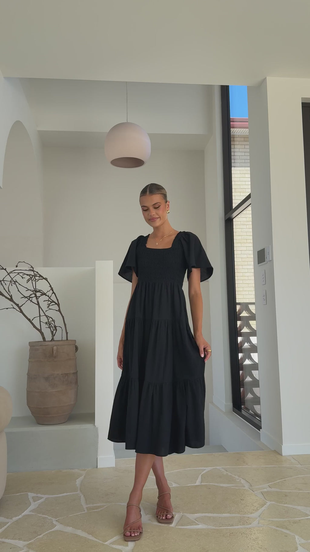 Black linen maxi dress with smocked bodice and flutter sleeves