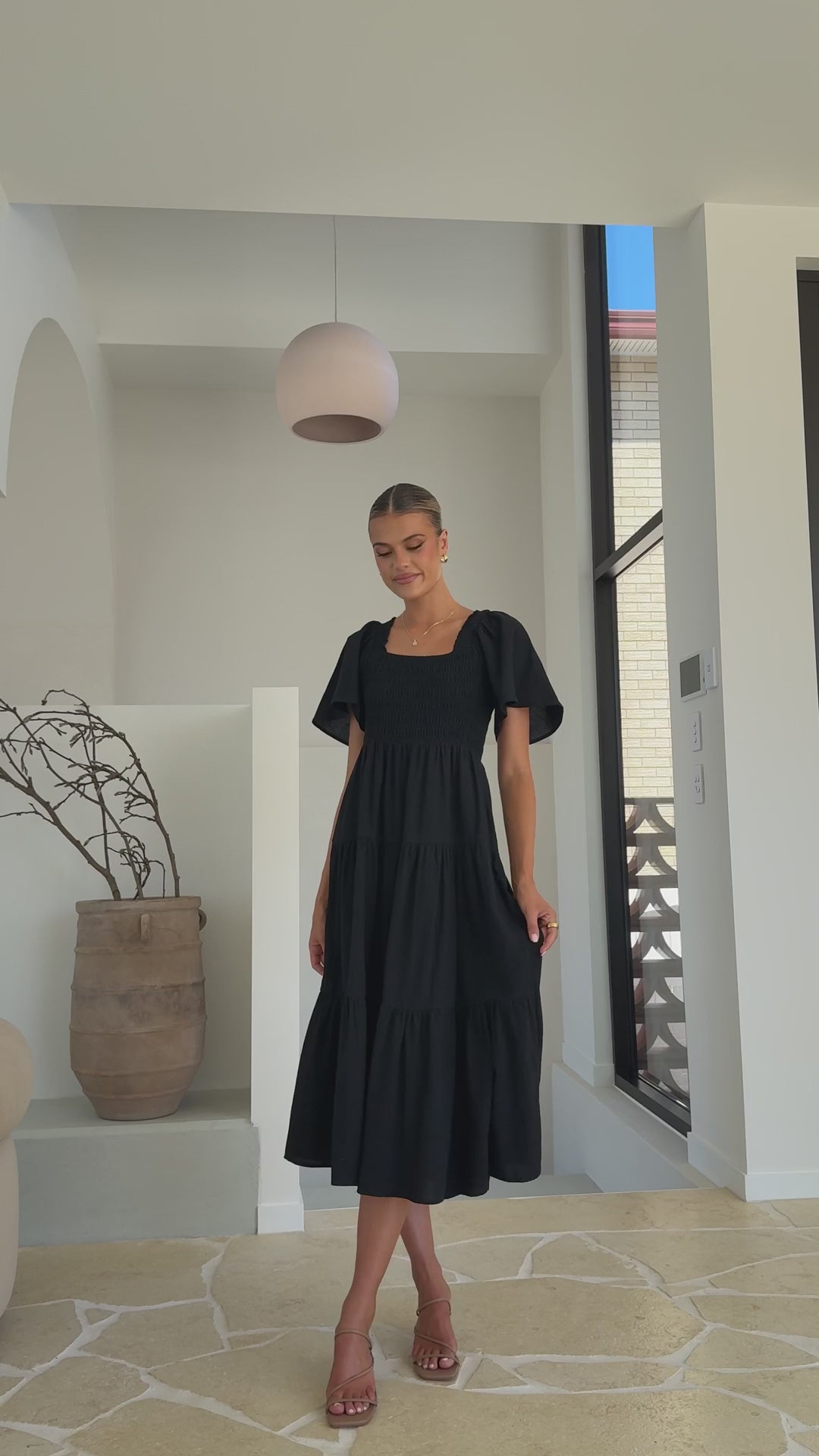 Black linen maxi dress with smocked bodice and flutter sleeves