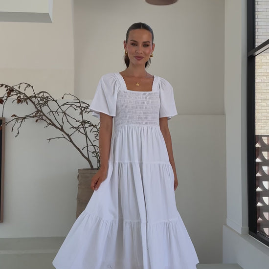 White midi dress with smocked front and back, puff sleeves, and tiered skirt