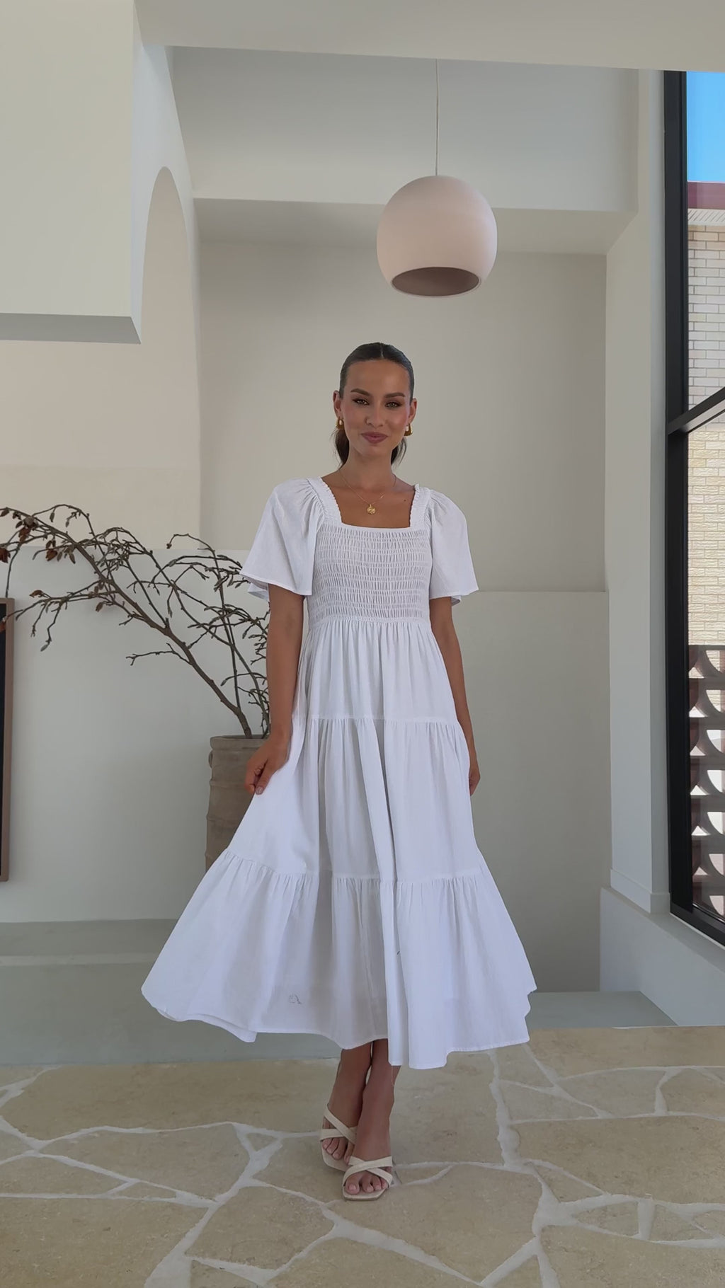 White midi dress with smocked front and back, puff sleeves, and tiered skirt