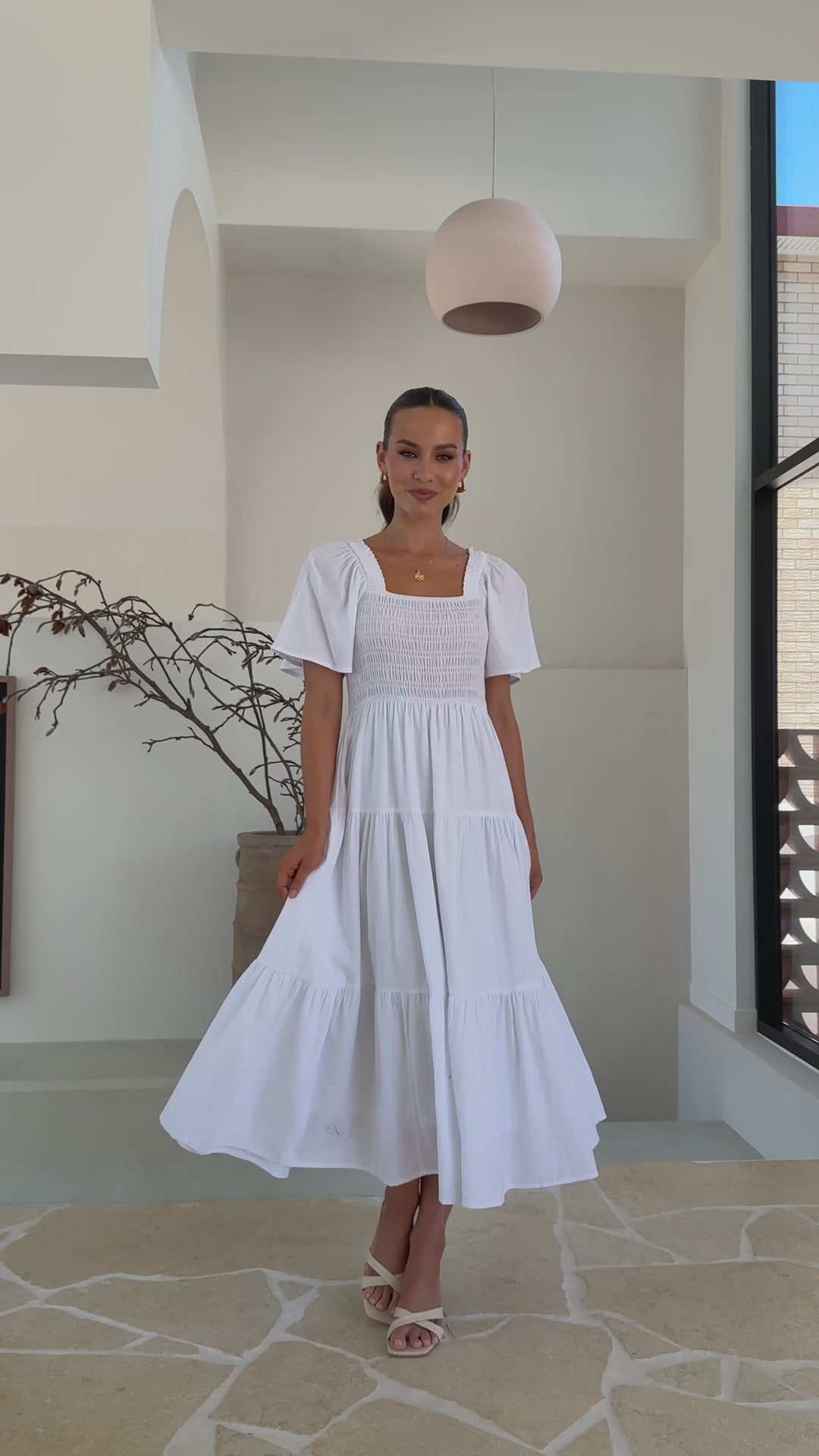 White midi dress with smocked front and back, puff sleeves, and tiered skirt