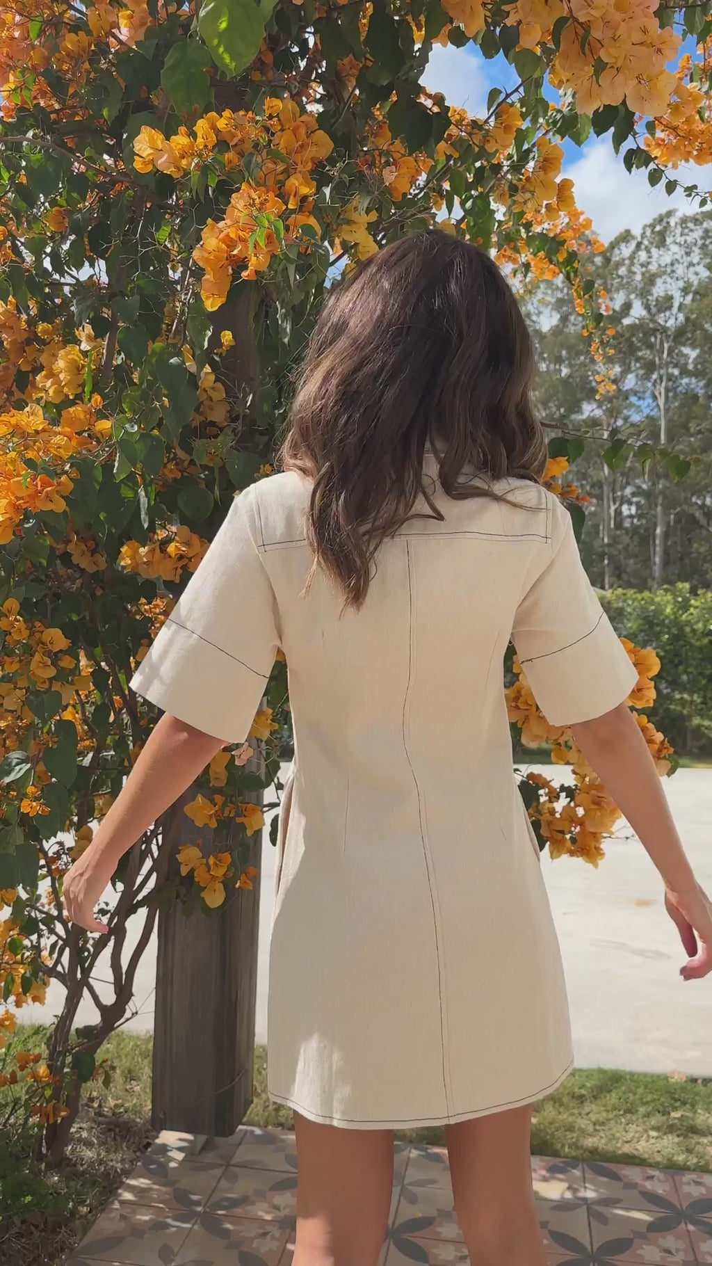 White denim button-down mini dress with short sleeves and side pockets