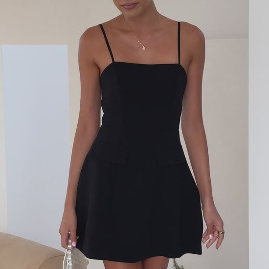 Black banana crepe mini dress with spaghetti straps and tailored fit