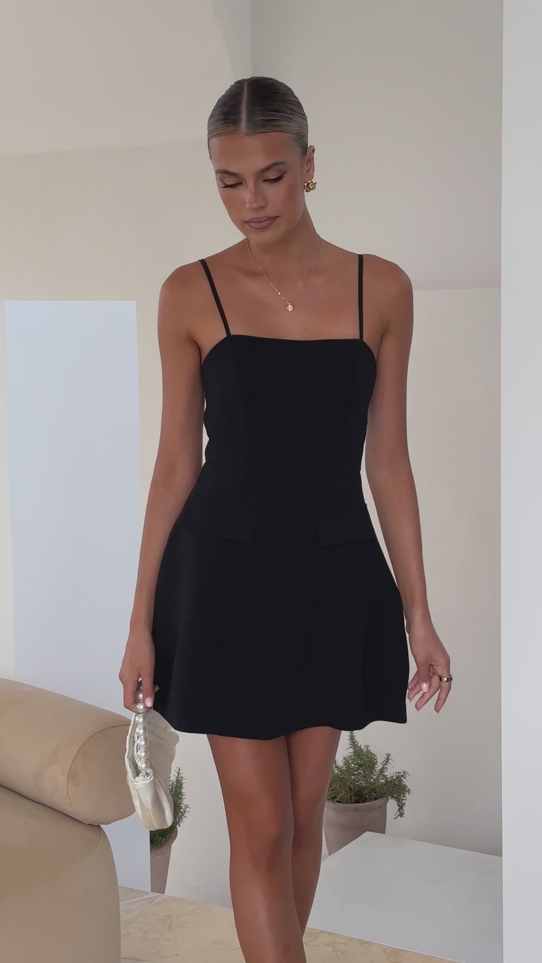 Black banana crepe mini dress with spaghetti straps and tailored fit