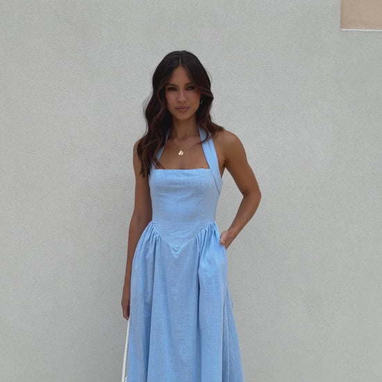 Powder blue linen midi dress with halter neckline, flared skirt, and smocked back