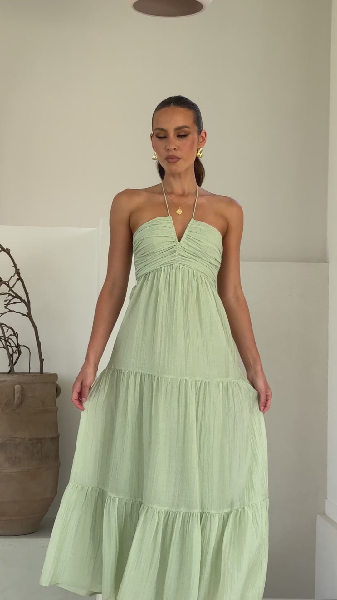 Sage green moss cotton maxi dress with halter neckline and tiered skirt