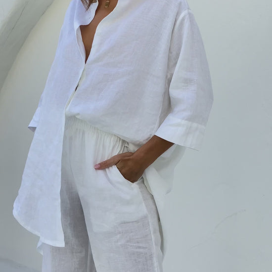 White linen shirt with longline back, 3/4 sleeves, and button front