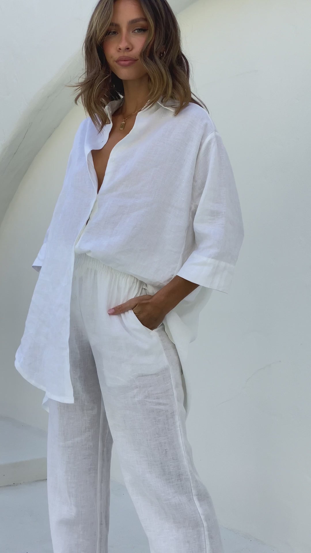White linen shirt with longline back, 3/4 sleeves, and button front
