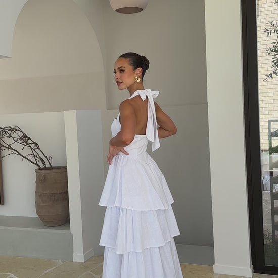 White crepe tiered maxi dress with halter neckline and back tie-up bow