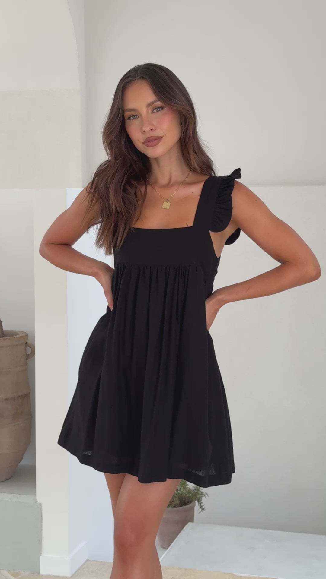 Black cotton mini dress with ruffle straps and square neckline
