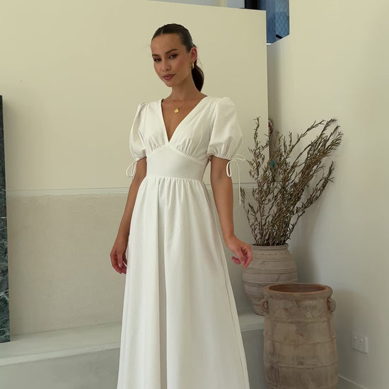 White linen maxi dress with puff sleeves, V-neckline, and smocked back