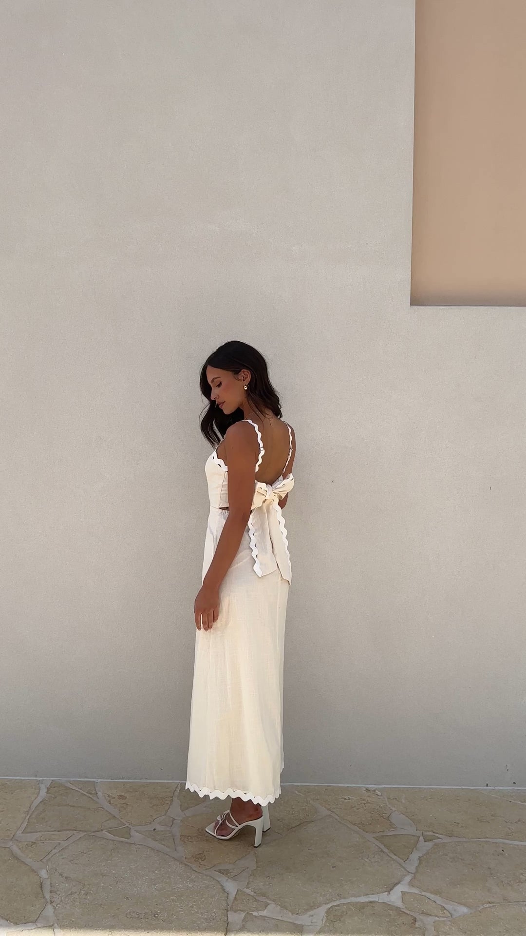 Ivory linen midi dress with scalloped straps and oversized back bow