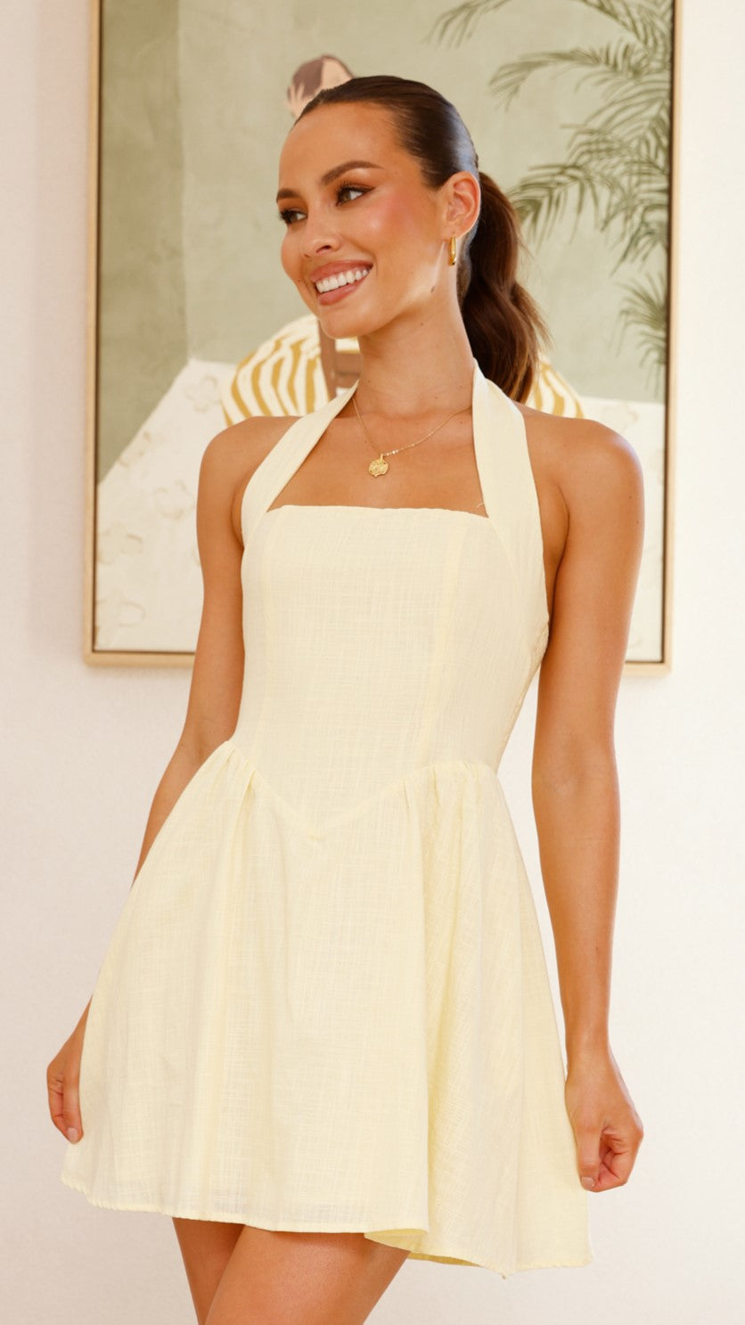 Butter yellow linen mini dress with halter straps, flared skirt, and smocked back