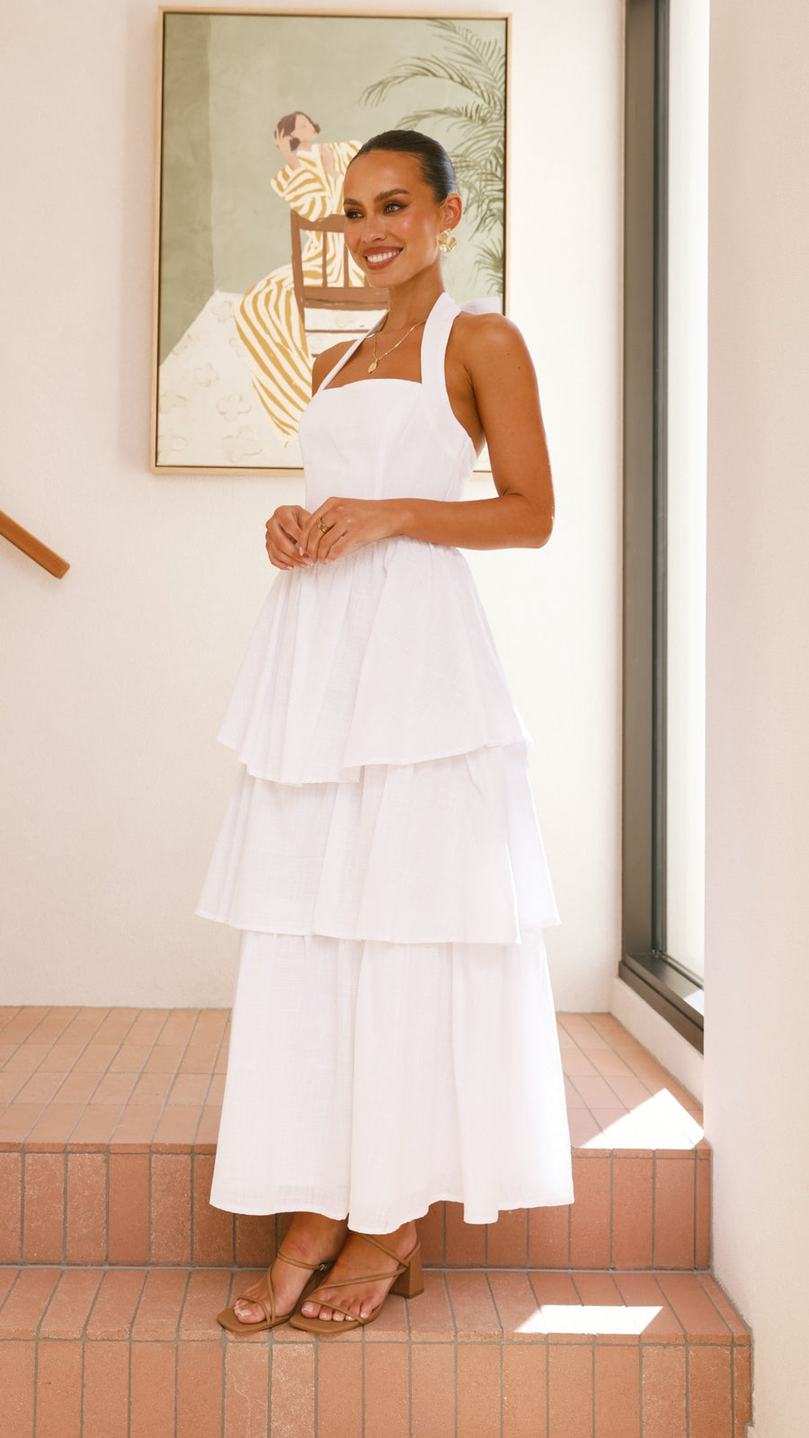 White crepe tiered maxi dress with halter neckline and back tie-up bow