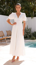 White linen maxi dress with puff sleeves, V-neckline, and smocked back
