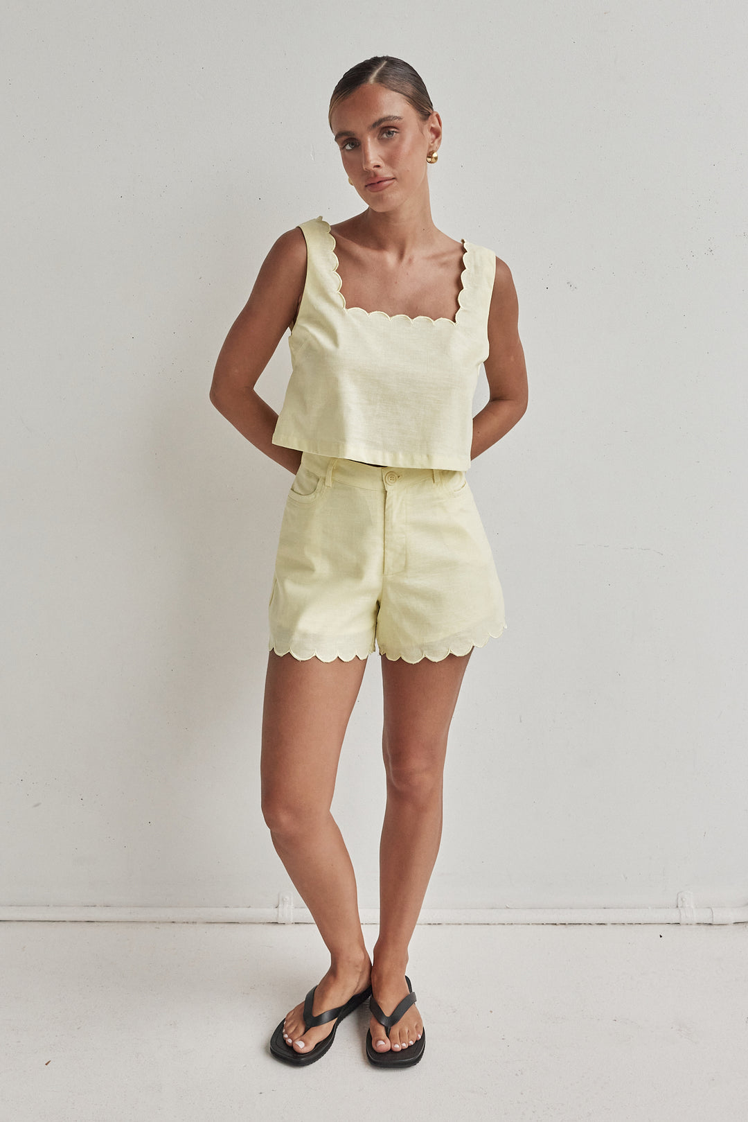 Butter yellow linen crop top with scalloped hem and sleeveless design