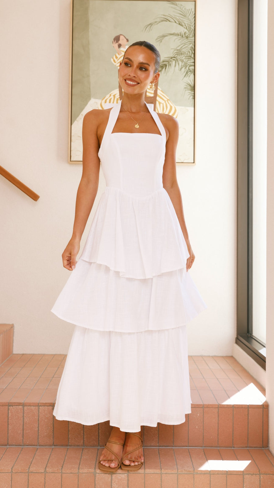 White crepe tiered maxi dress with halter neckline and back tie-up bow