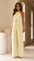 Model wearing butter yellow crepe halter top with front drape and open back