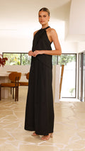 Model wearing black crepe halter top with draped neckline and open back

