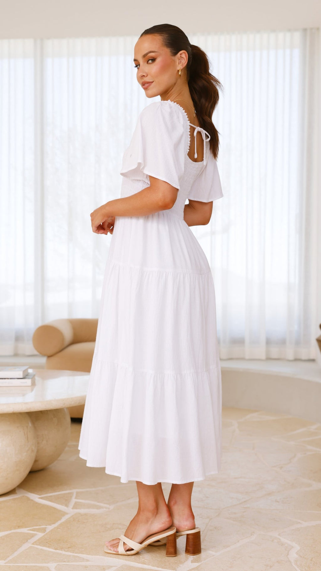 White midi dress with smocked front and back, puff sleeves, and tiered skirt