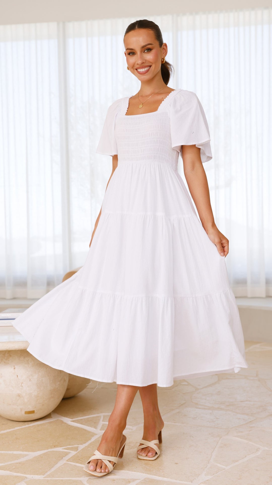 White midi dress with smocked front and back, puff sleeves, and tiered skirt