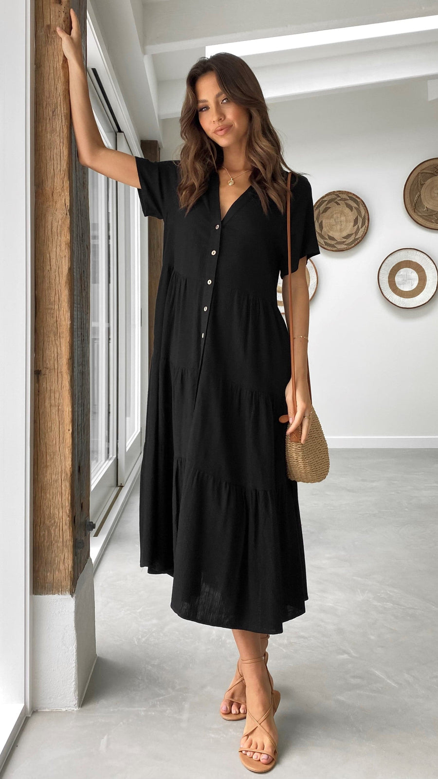 Black linen midi dress with short sleeves, tiered skirt, and button-down front