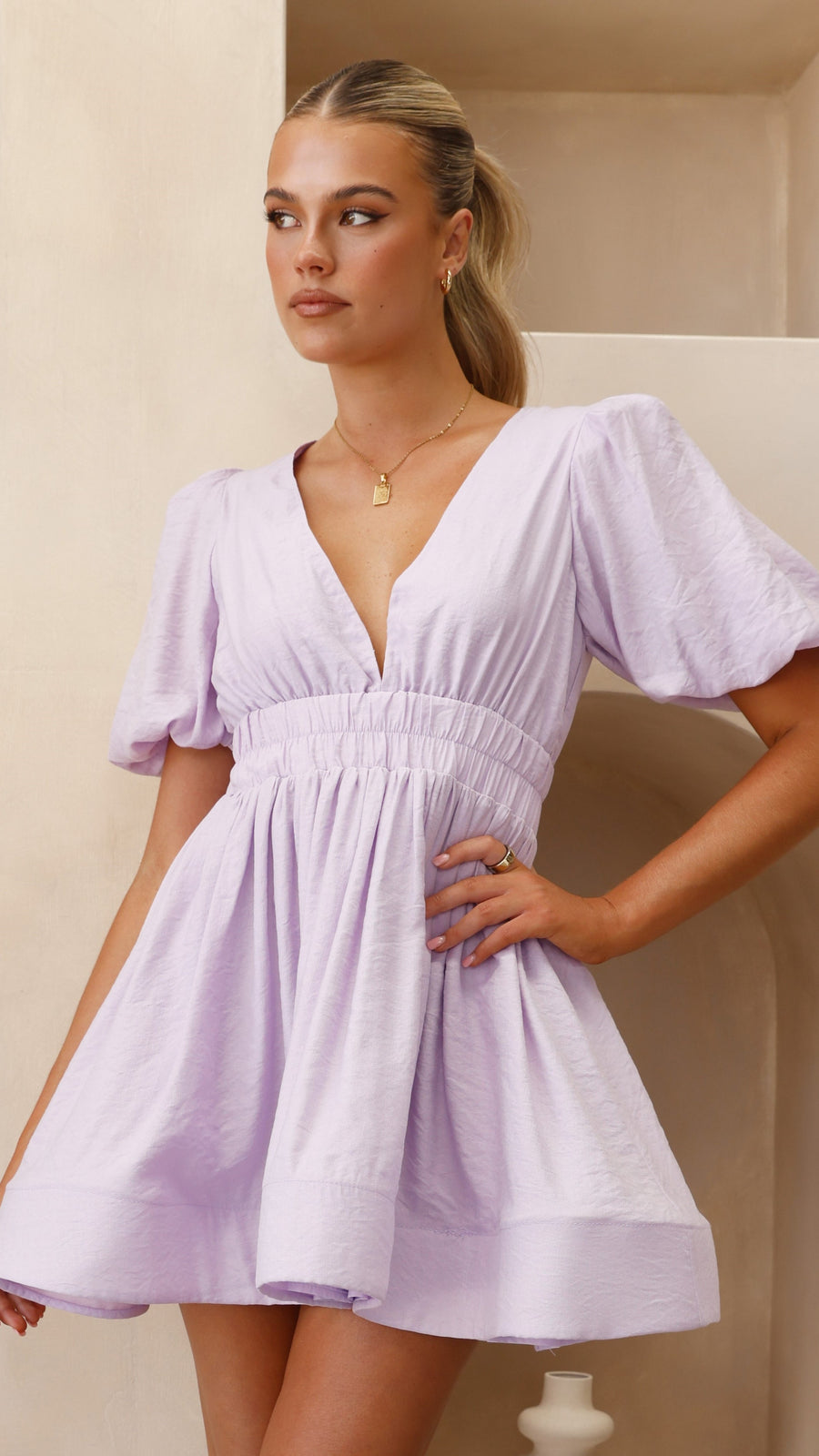 Lavender crepe mini dress with puff sleeves, plunging V-neckline, and flared hem