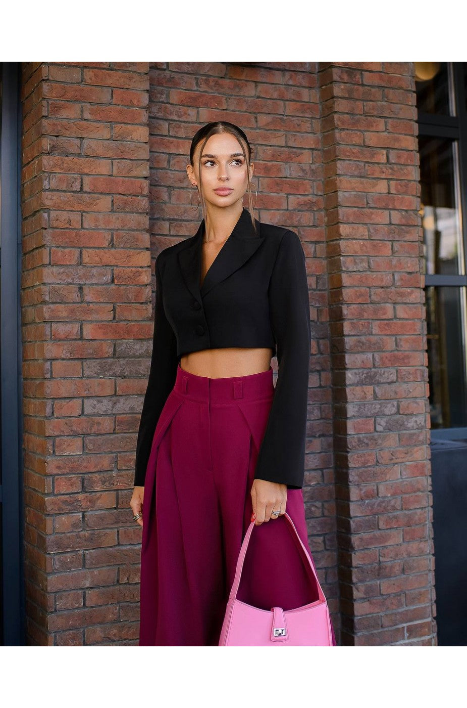 Model wearing cropped black banana crepe blazer top