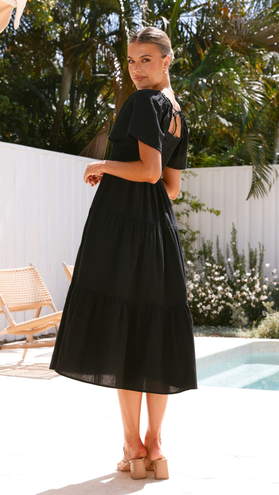 Black linen maxi dress with smocked bodice and flutter sleeves