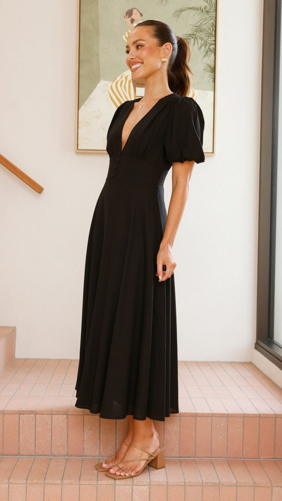 black linen puff sleeve maxi dress with a deep V neckline and flared skirt