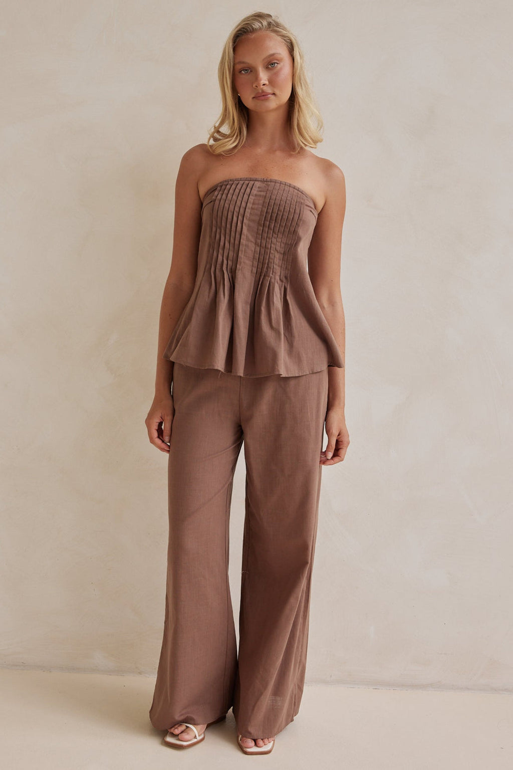 Brown linen co-ord set with strapless pleated top and wide-leg pants