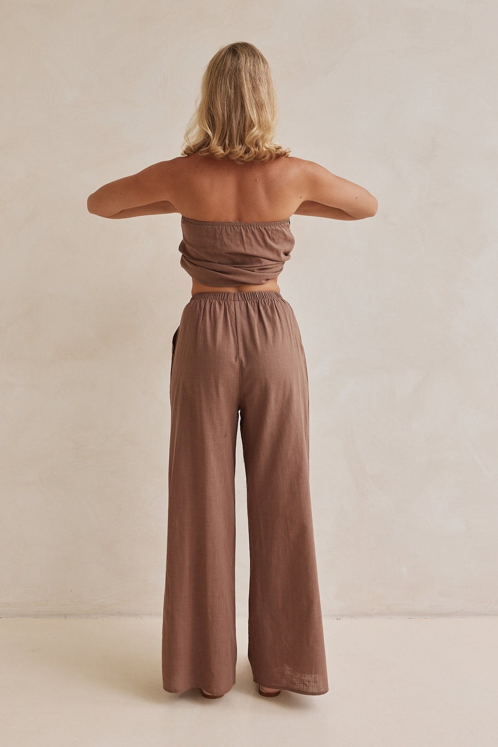 Brown linen co-ord set with strapless pleated top and wide-leg pants