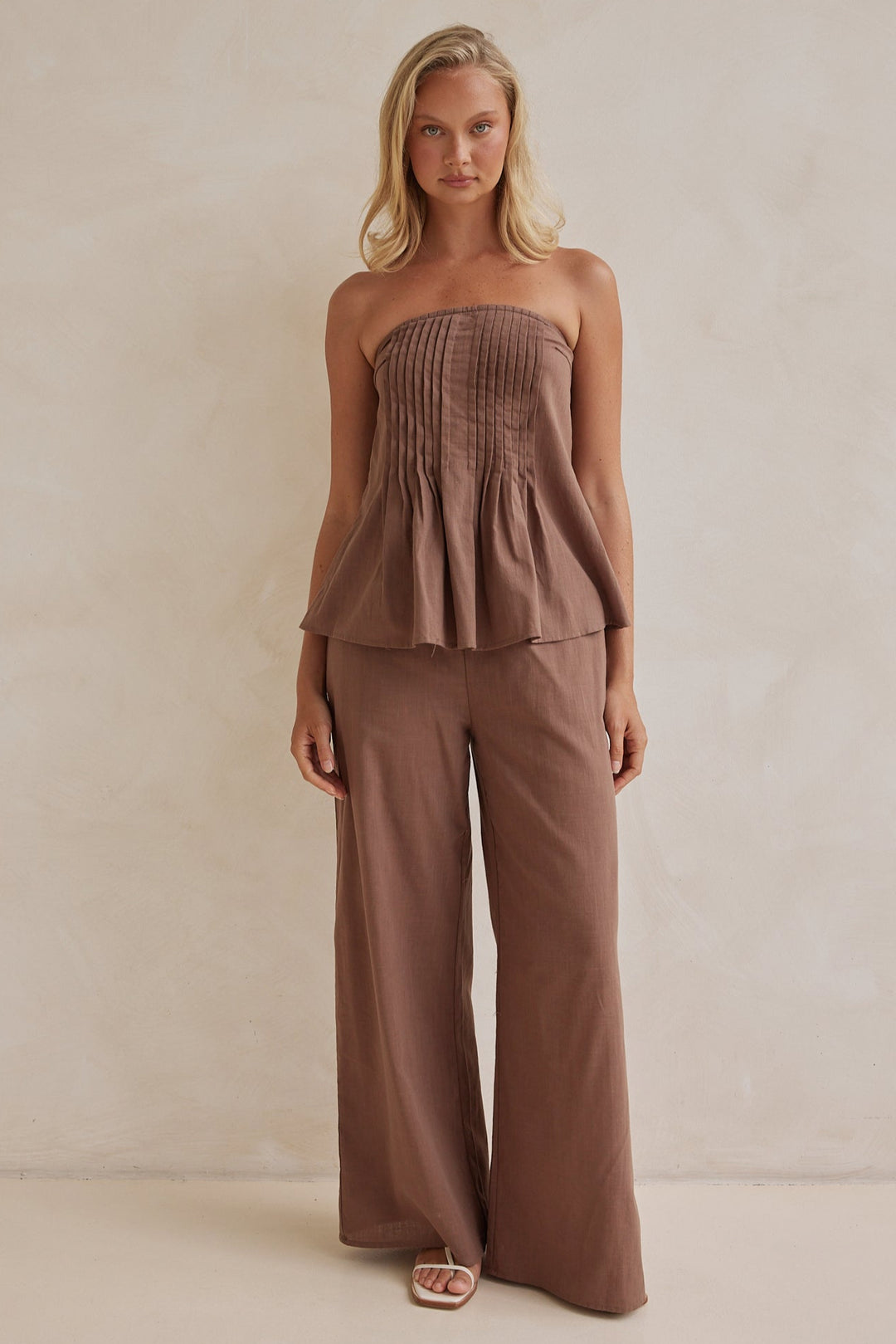 Brown linen co-ord set with strapless pleated top and wide-leg pants