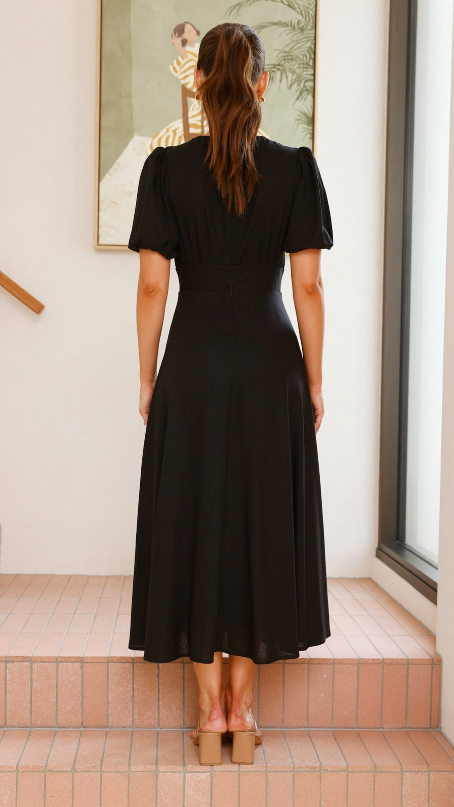 black linen puff sleeve maxi dress with a deep V neckline and flared skirt