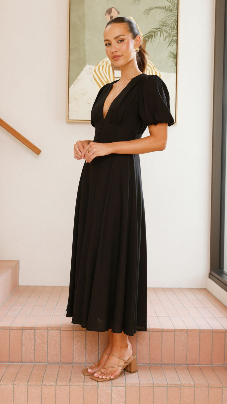 black linen puff sleeve maxi dress with a deep V neckline and flared skirt
