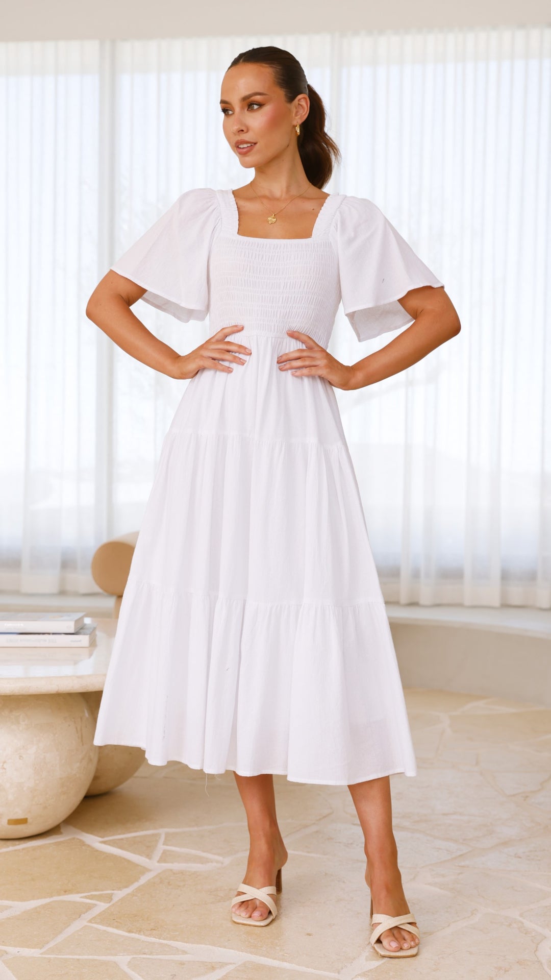 White midi dress with smocked front and back, puff sleeves, and tiered skirt