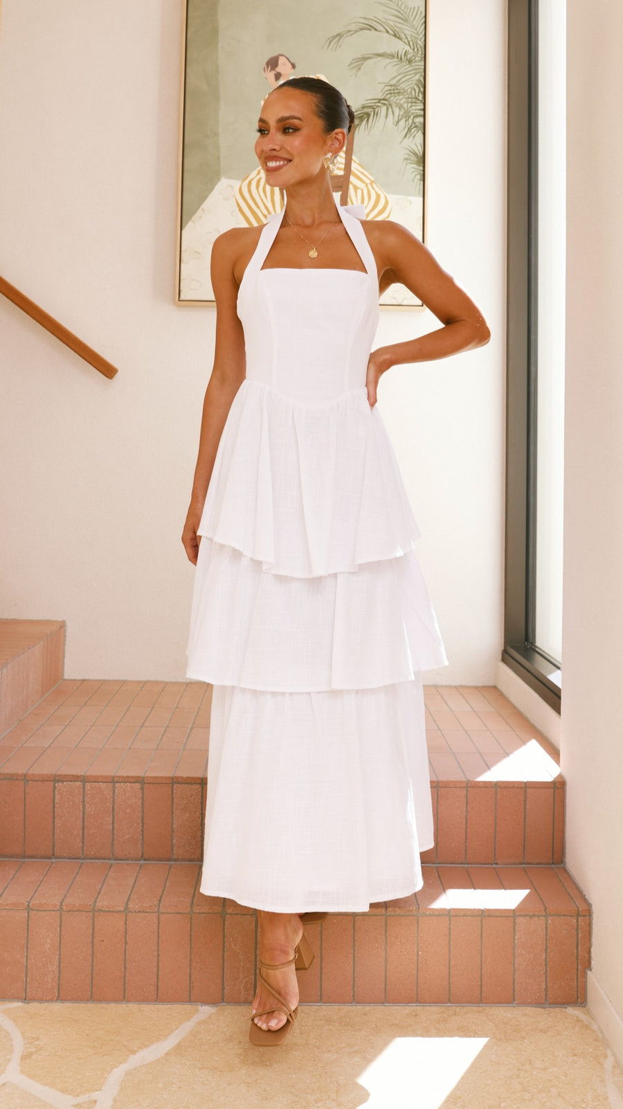 White crepe tiered maxi dress with halter neckline and back tie-up bow